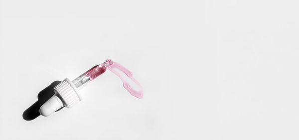 Pipette with peeling on white background. cosmetics and healthcare concept. dose of serum, retinol