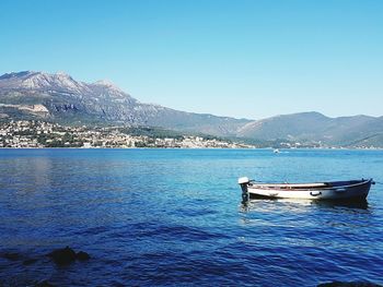 Scenic view of lake against clear blue sky