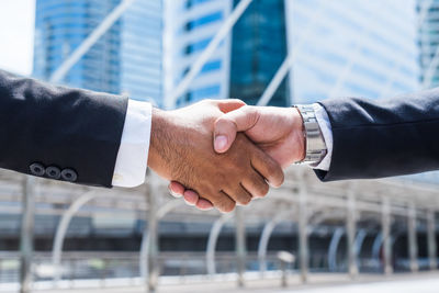 Cropped image of man with hand holding camera