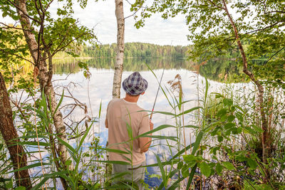 Rear view of man standing by plants