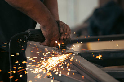 Cropped hand of man welding metal