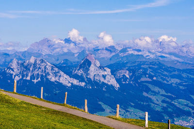 Scenic view of mountains against blue sky