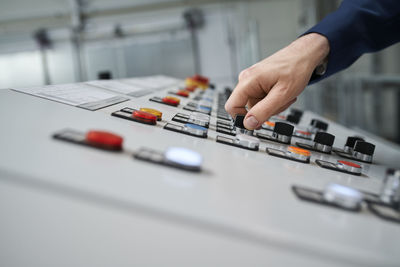 Close-up of hand operating control panel