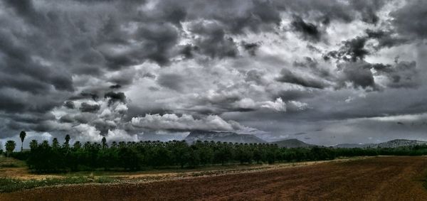 Scenic view of dramatic landscape against cloudy sky