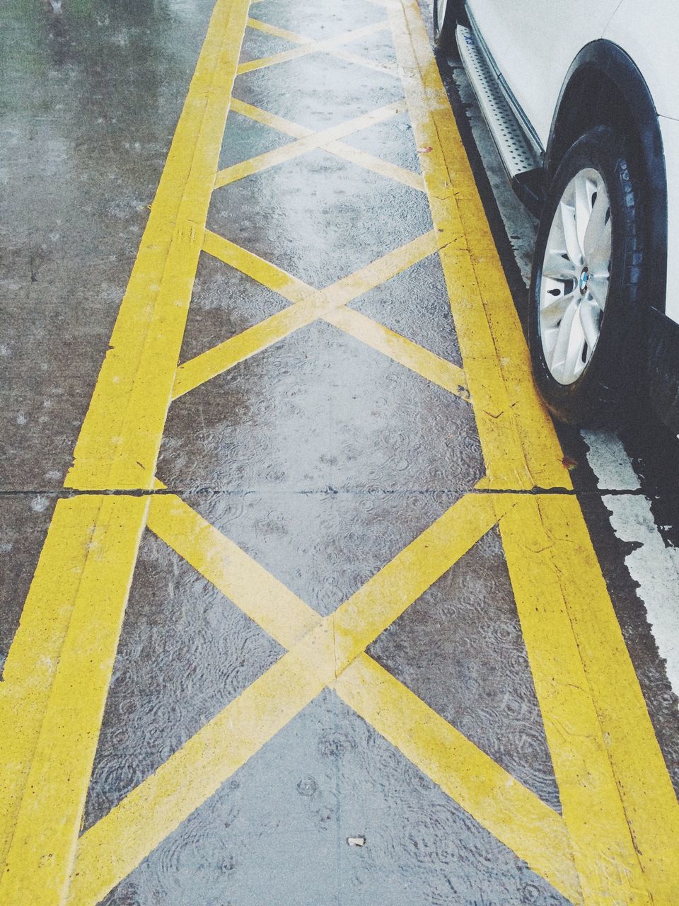 yellow, transportation, road marking, street, high angle view, asphalt, road, guidance, outdoors, day, arrow symbol, no people, mode of transport, close-up, direction, pattern, pavement, sign, the way forward, geometric shape