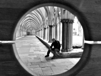Rear view of woman walking in corridor of building