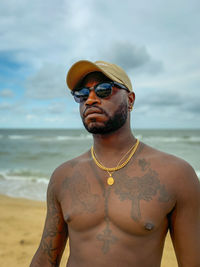 Mid adult man wearing sunglasses on beach