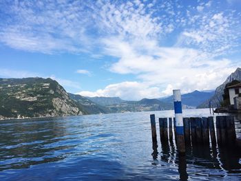 Scenic view of lake and mountains against blue sky