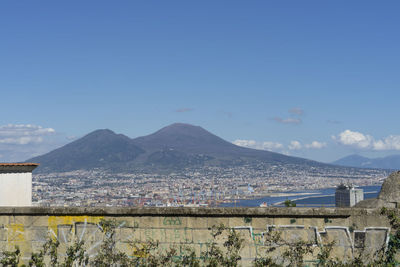 Panoramic view of buildings and mountains against sky