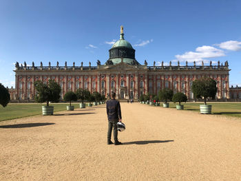 Full length of man standing against building and sky