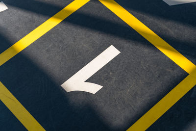 High angle view of arrow symbol on road