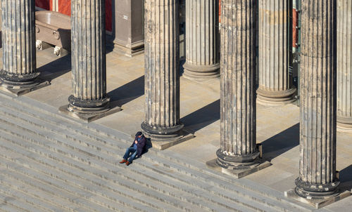 High angle view of man sitting on staircase