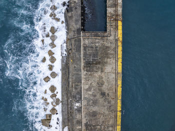 Bird's eye view of the harbour of stanley with a breakwater sea wall pier, tasmania, australia.