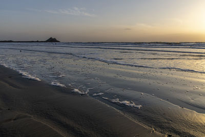 Scenic view of beach against sky during sunset