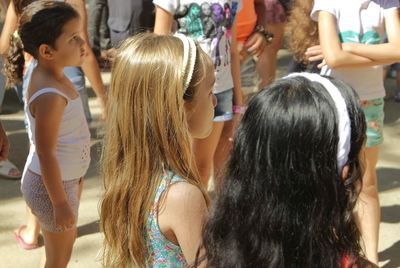 Rear view of siblings standing in corridor