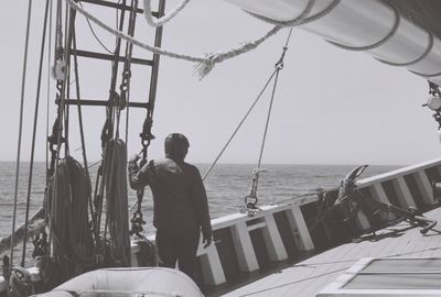 Man standing in ship against sky