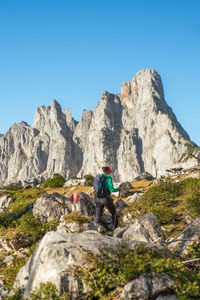 Low angle view of rocks on mountain against clear sky