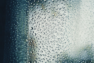 Full frame shot of wet glass window in rainy season