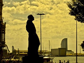 Silhouette of man statue against sky