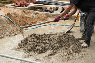 Low section of manual worker working at construction site