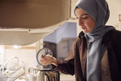 Woman preparing evening tea at home