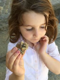 Close-up of girl holding horse