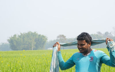 Man standing on field against clear sky