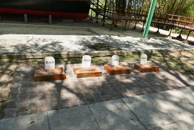 High angle view of empty chairs by railing