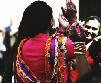 Rear view of women standing outdoors