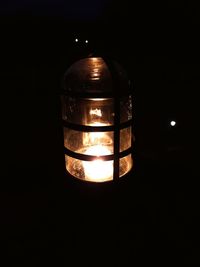 Close-up of illuminated lamp in darkroom