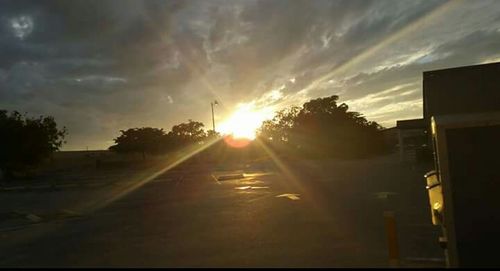 View of road against sunset sky