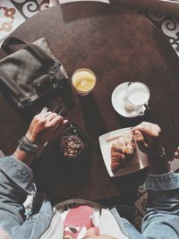 High angle view of hand holding drink on table at restaurant