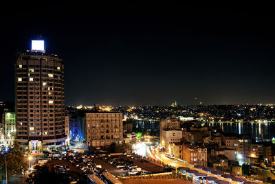 High angle view of illuminated buildings against sky at night