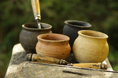 Close-up of pots and hand tools