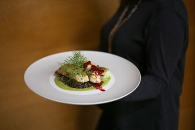 Close-up of woman holding food in plate