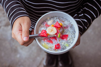 High angle view of woman holding ice cream