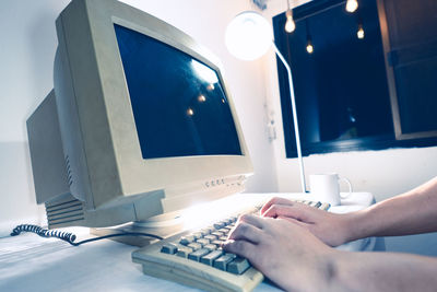 Midsection of woman using mobile phone on table