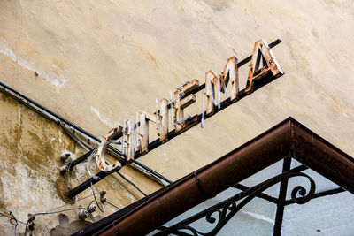 Low angle view of old cinema sign on wall