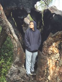 Portrait of man standing by tree