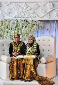 Young couple sitting in a room, wedding javanese