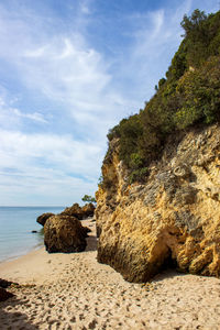 Rocks on beach against sky