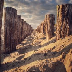 Narrow pathway along rocky landscape against sky