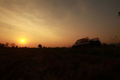 Scenic view of field against sky during sunset