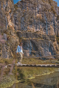 Rear view of man walking on rock