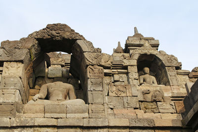 Borobudur temple with the buddha statue during sunrise, yogyakarta, indonesia