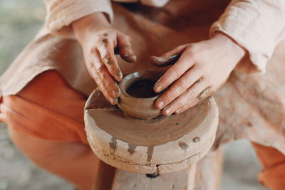 Close-up of person working on pottery wheel