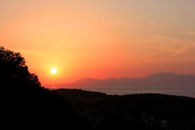 Scenic view of silhouette mountains against sky during sunset