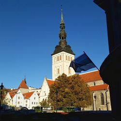 Low angle view of bell tower against blue sky