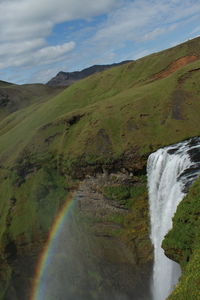 Scenic view of waterfall against sky