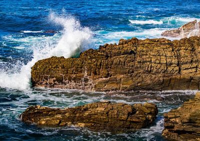 Waves splashing on rocks at shore